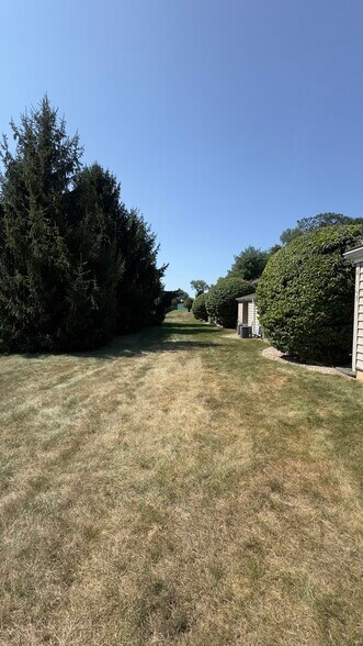 Large grass behind the home - 5 Evergreen Dr