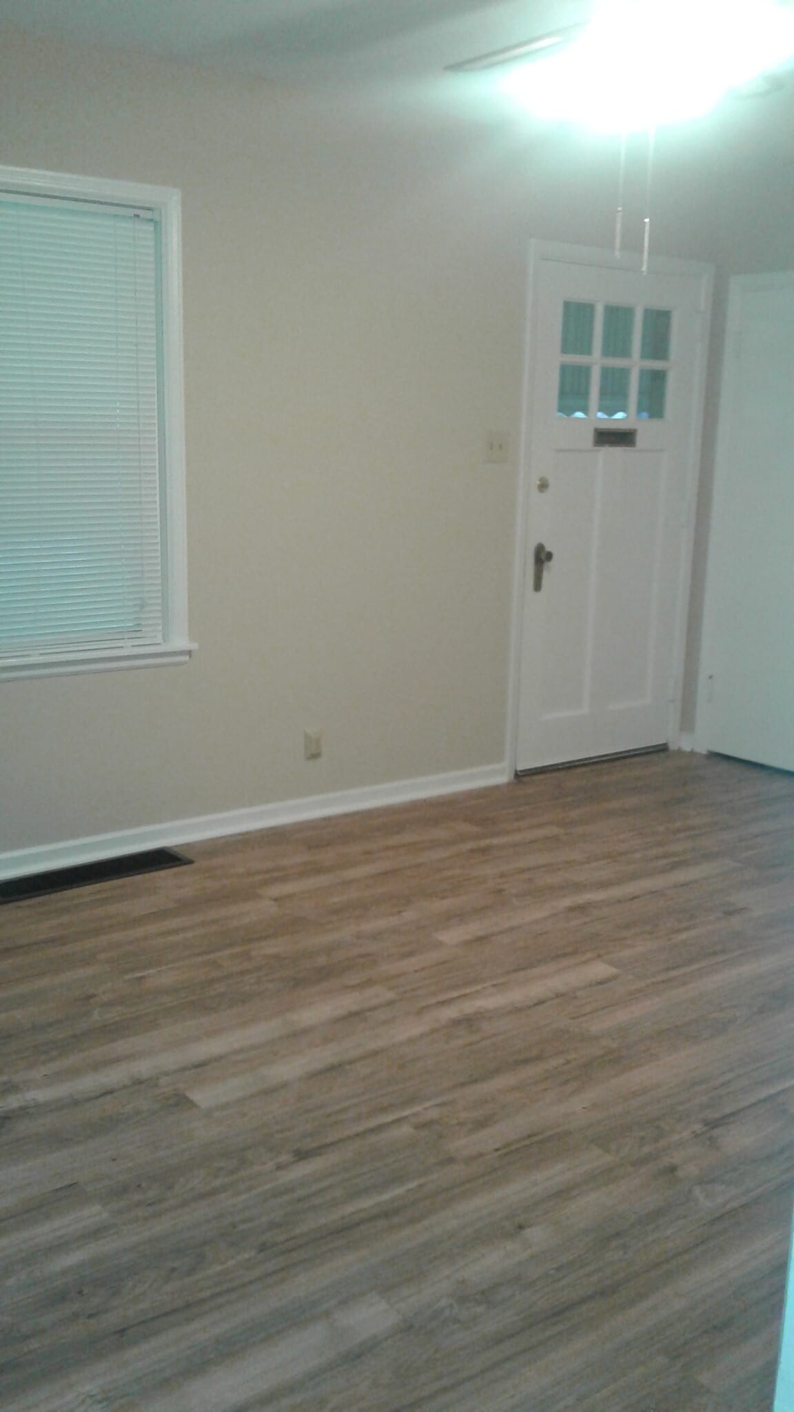 Living room with fresh paint and new wood floor - 1654 Pell Dr