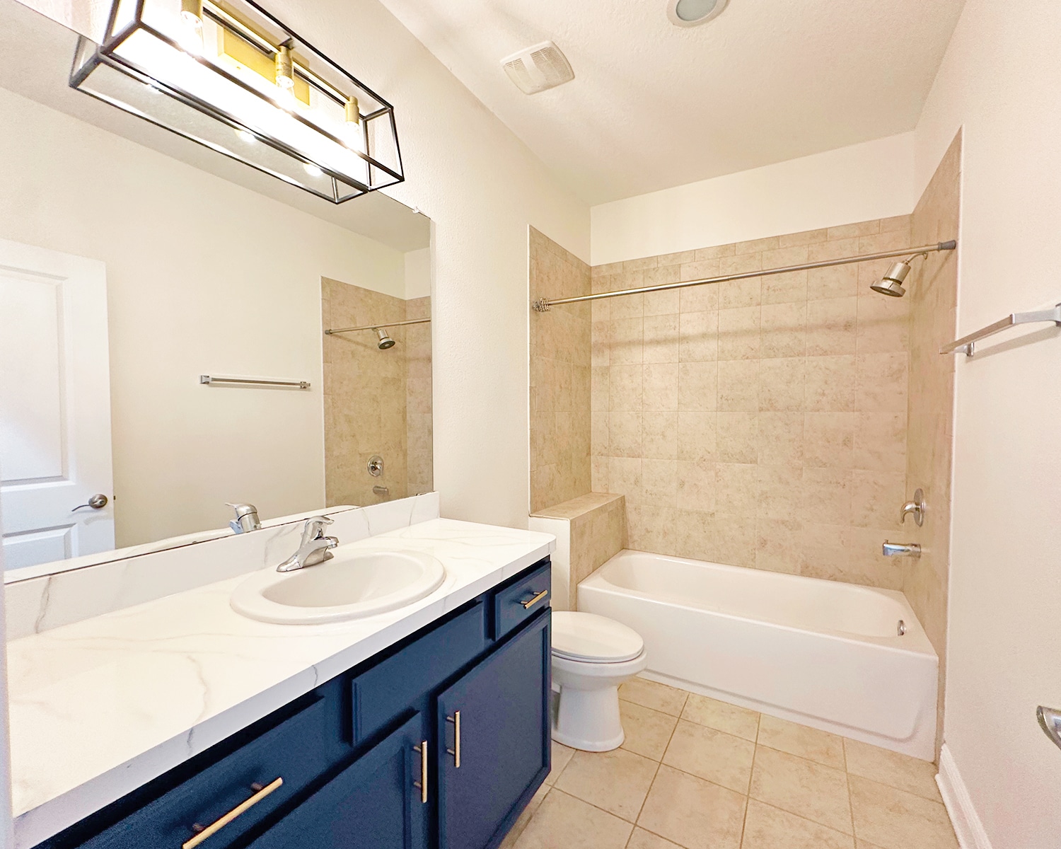 Full guest bathroom with modern fixtures and functional layout. - 1736 W Walnut St