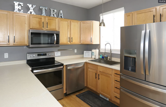 Kitchen provides ample cupboard space for food, storage and residents' cooking utensils - 584 N 8th W