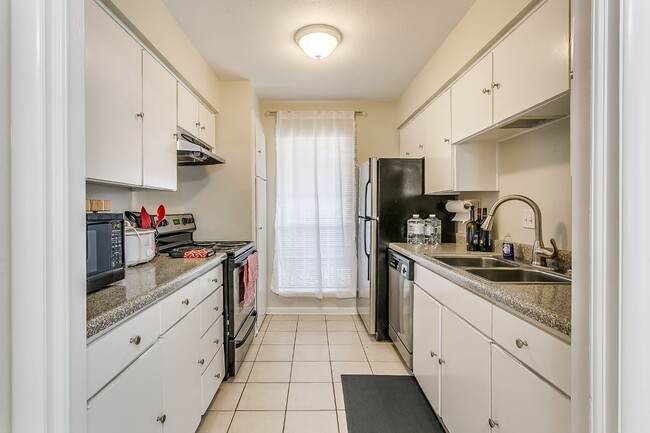 Fully equipped kitchen with refrigerator and ice maker, microwave, stove/oven, drip coffee maker, dishwasher, and lots of cabinets. - 4901 Bryce Ave