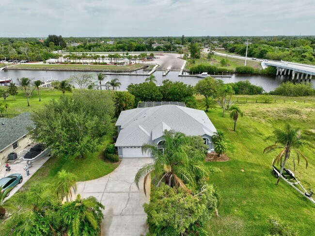 Building Photo - A BOATER'S PARADISE WITH THIS STUNNING 3 BEDROOM, 2 BATH WATERFRONT POOL HOME W/DOCK & BOAT LIFT ...
