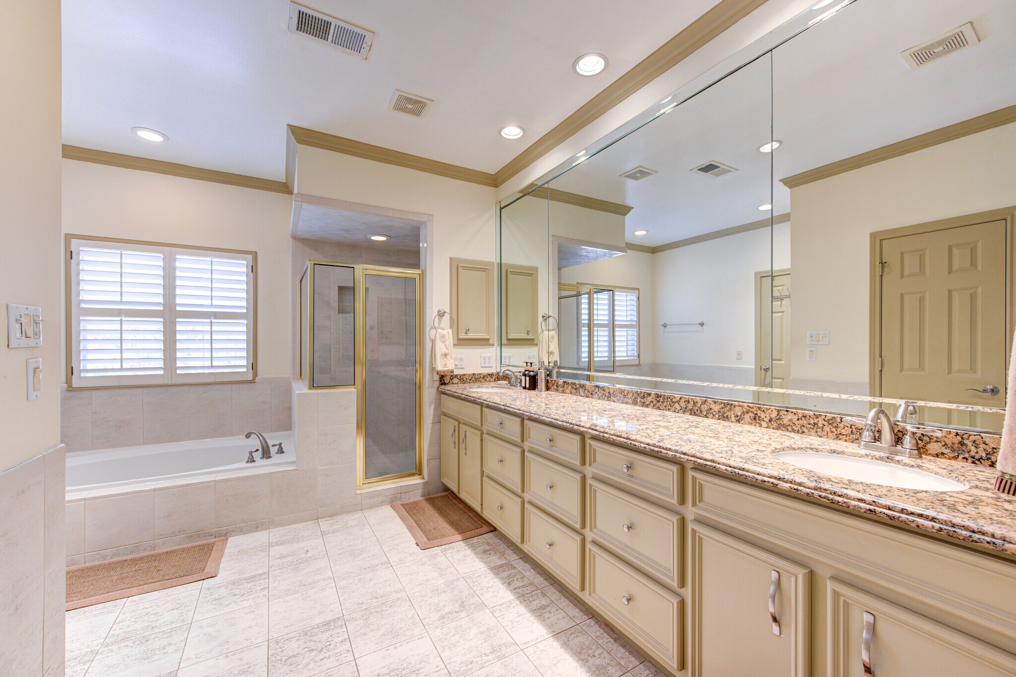 Primary bath, has 2 showers, 2 commode areas, jacuzzi tub and large vanity with double sinks. - 6811 Staffordshire