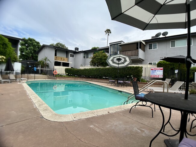 Plentiful pool furniture with umbrellas for shade - 6301 Coldwater Canyon Ave