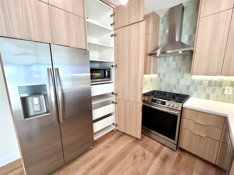 The kitchen is outfitted with a pantry with microwave and drawers. - 2221 Ocean Ave