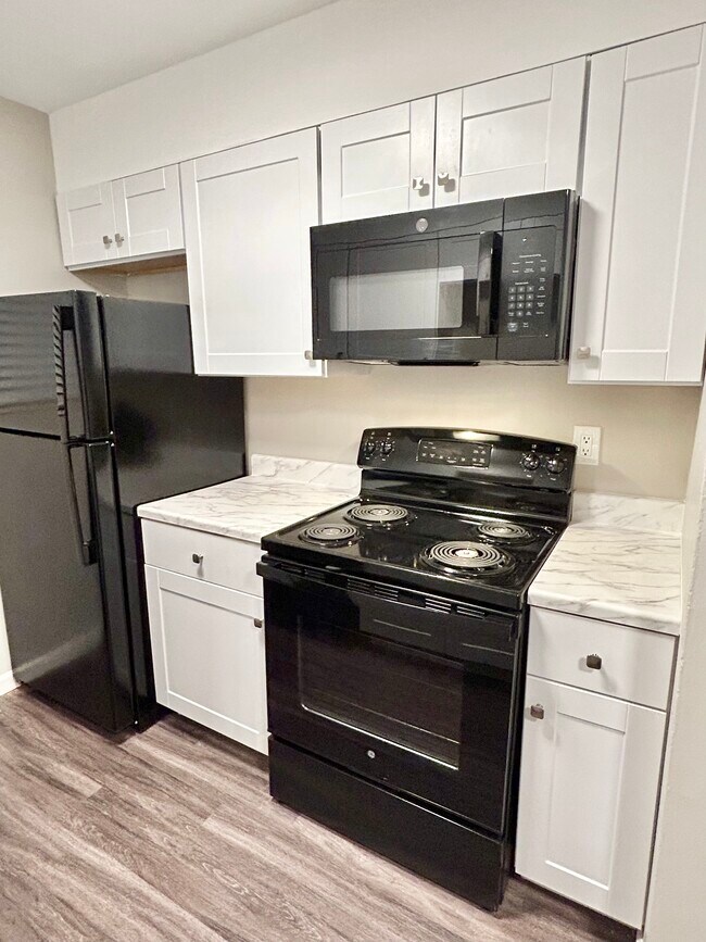 Experience modern culinary convenience with this stylishly designed kitchen. - GRACE LANDINGS APARTMENTS