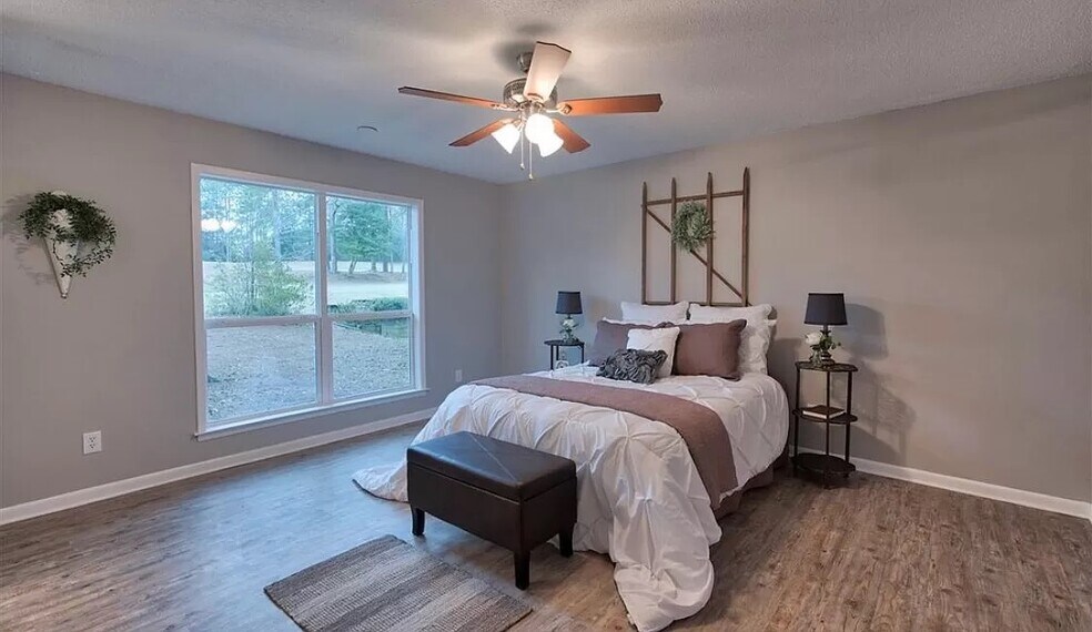 Master bedroom with view of backyard with walk-in bathroom and his and hers closets - 113 Penny Ln