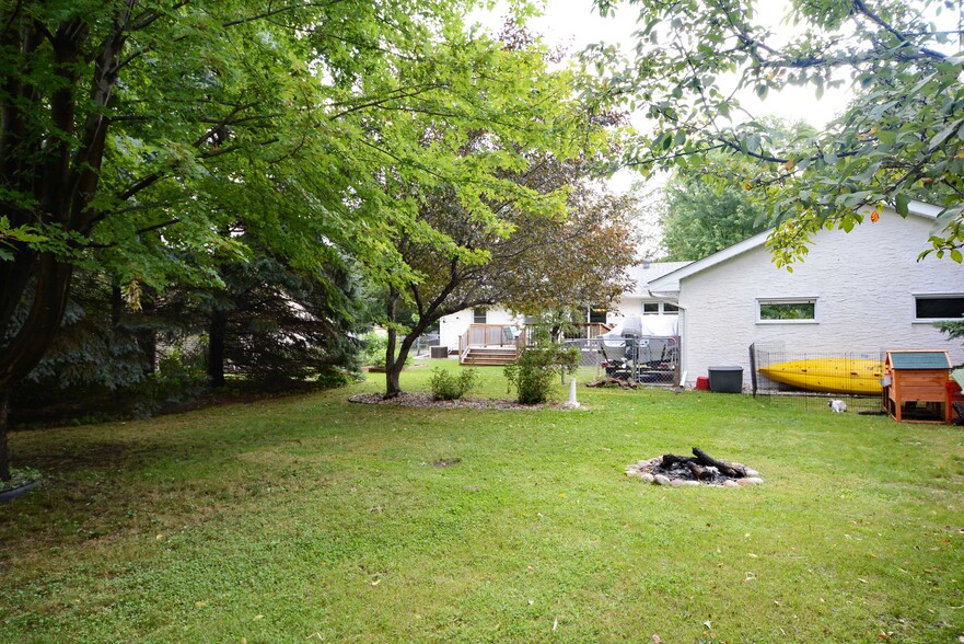 Backyard surrounded by tall trees and bushes - 4239 Diamond Dr