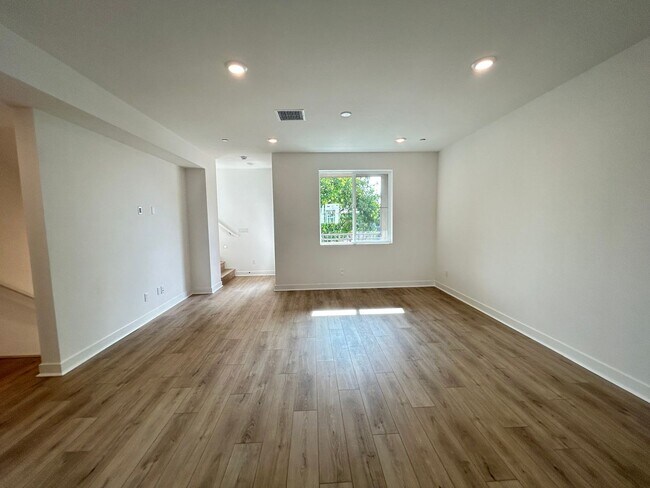 Building Photo - Gorgeous, 3 level townhome, featuring 2 car garage central Air, and in Unit laundry.