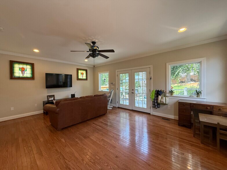 Family room with antique stained glass windows and glass doors to deck - 5715 7th St N