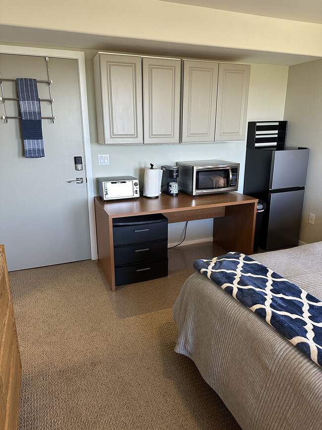 Entrance/exit door to hallway. Mini-kitchen includes dishes and utensils. - 7079 Engineers Rd