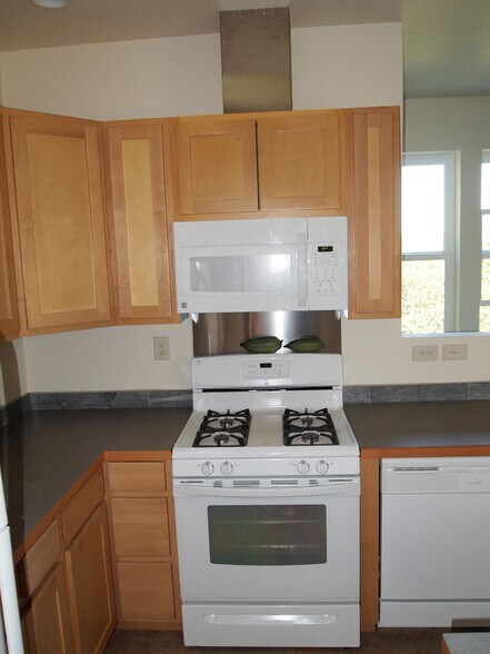 Kitchen: Gas range, fan, microwave, Dishwasher, Lots of daylight from window along access stairway - 6924 SE 108th Ave