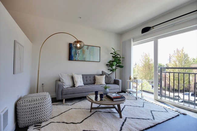CREW Apartments Apartment Home Living Room with Balcony View - Crew Apartments