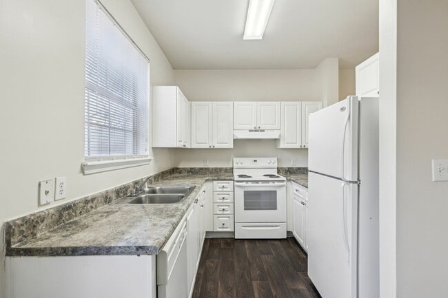 Experience modern cooking in this elegant kitchen with sleek surfaces and ample storage. - Redwine Creek