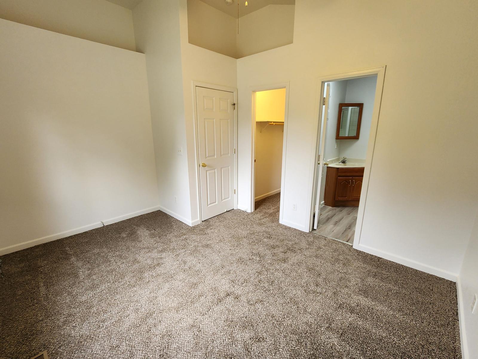 Primary Bedroom with view into closet and 3/4 bath - 525 N Diamond Ave