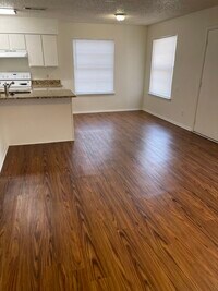 Building Photo - MOVE-IN READY. Single level, pet friendly front-end fourplex townhome, UPGRADED WIDE PLANK FLOORI...