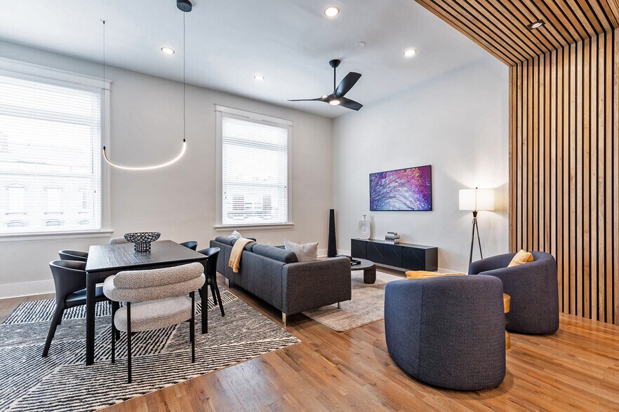 Spacious great room for living and dining. Art work is actually a TV. - 795 E McMillan St