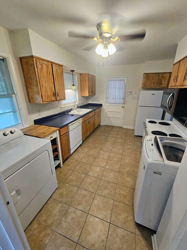 Building Photo - Brick Ranch Charmer with Hardwoods, In-Unit Laundry & Fenced Yard — Available Now!