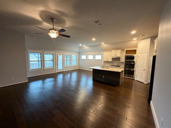 Building Photo - Four bed two bath on a corner lot with a pool in Sunfield. Gas cook top, double ovens. Open kitch...