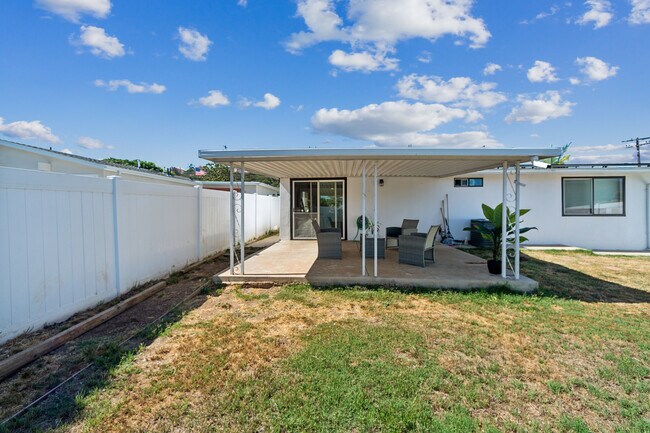 Spacious backyard featuring outdoor furniture, perfect for relaxing and entertaining! - 9853 Saint George St