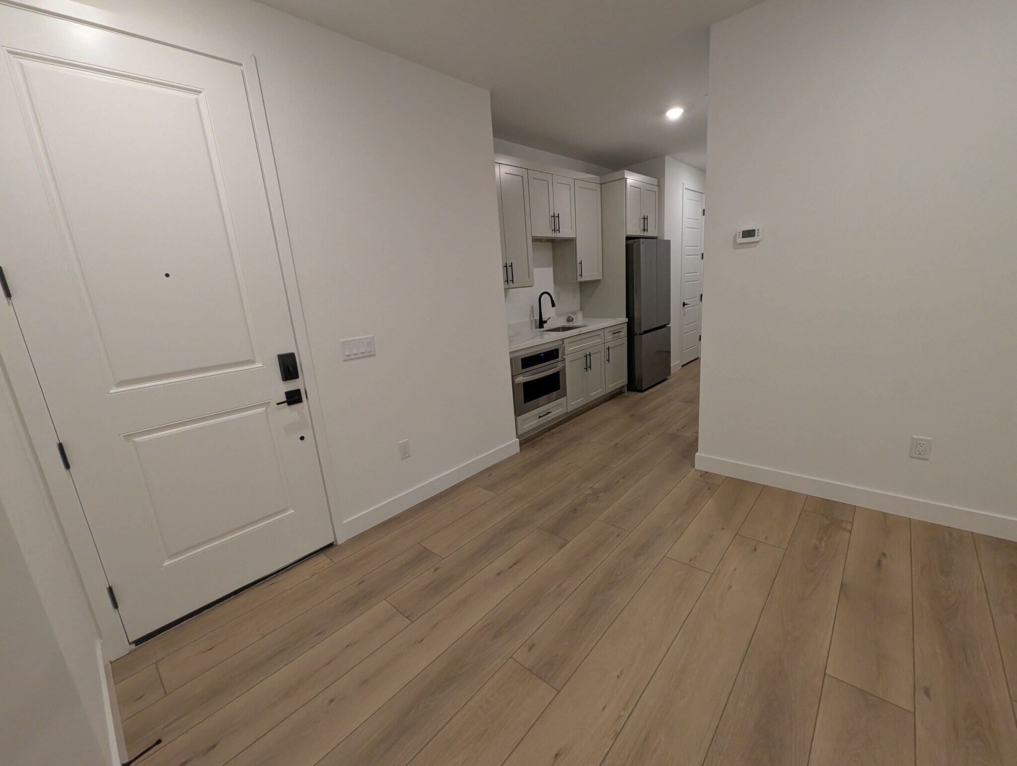 New kitchenette and large 18' x 13' living room with modern plank flooring - 628 S Cecita Wy