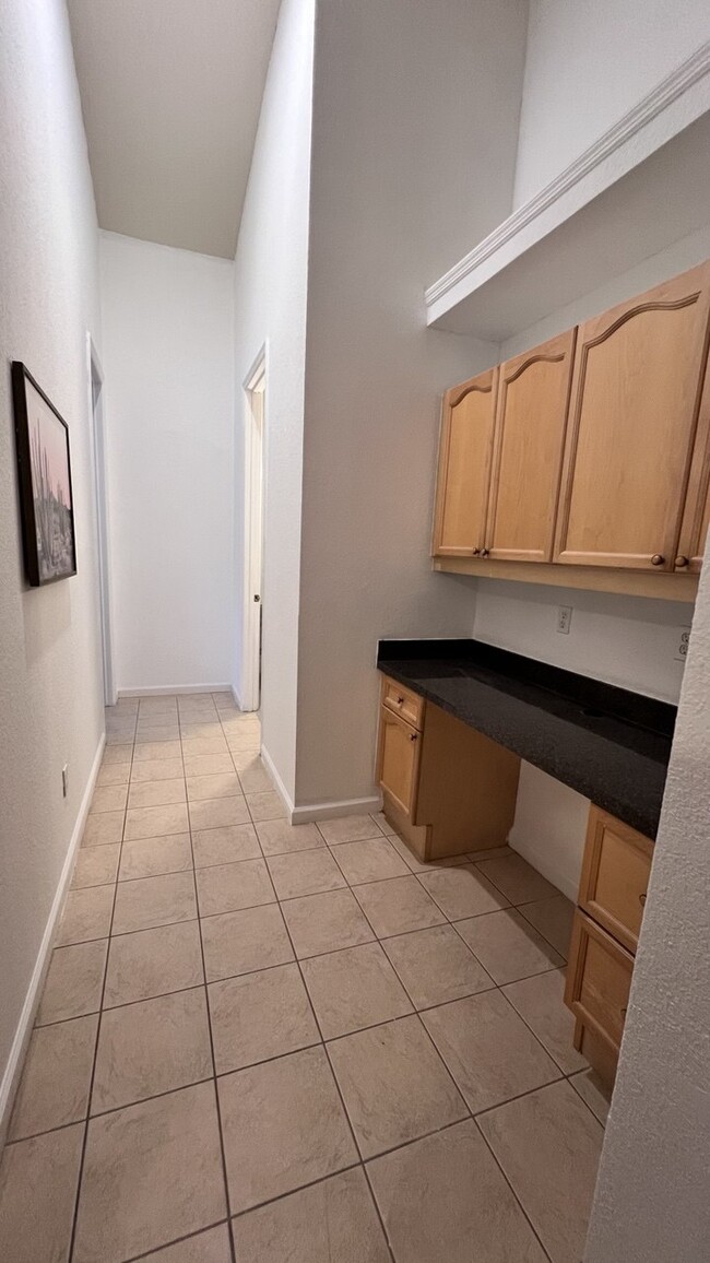 Hallway leading to bathroom and room includes cabinets and office - 3540 Maple Ridge Loop