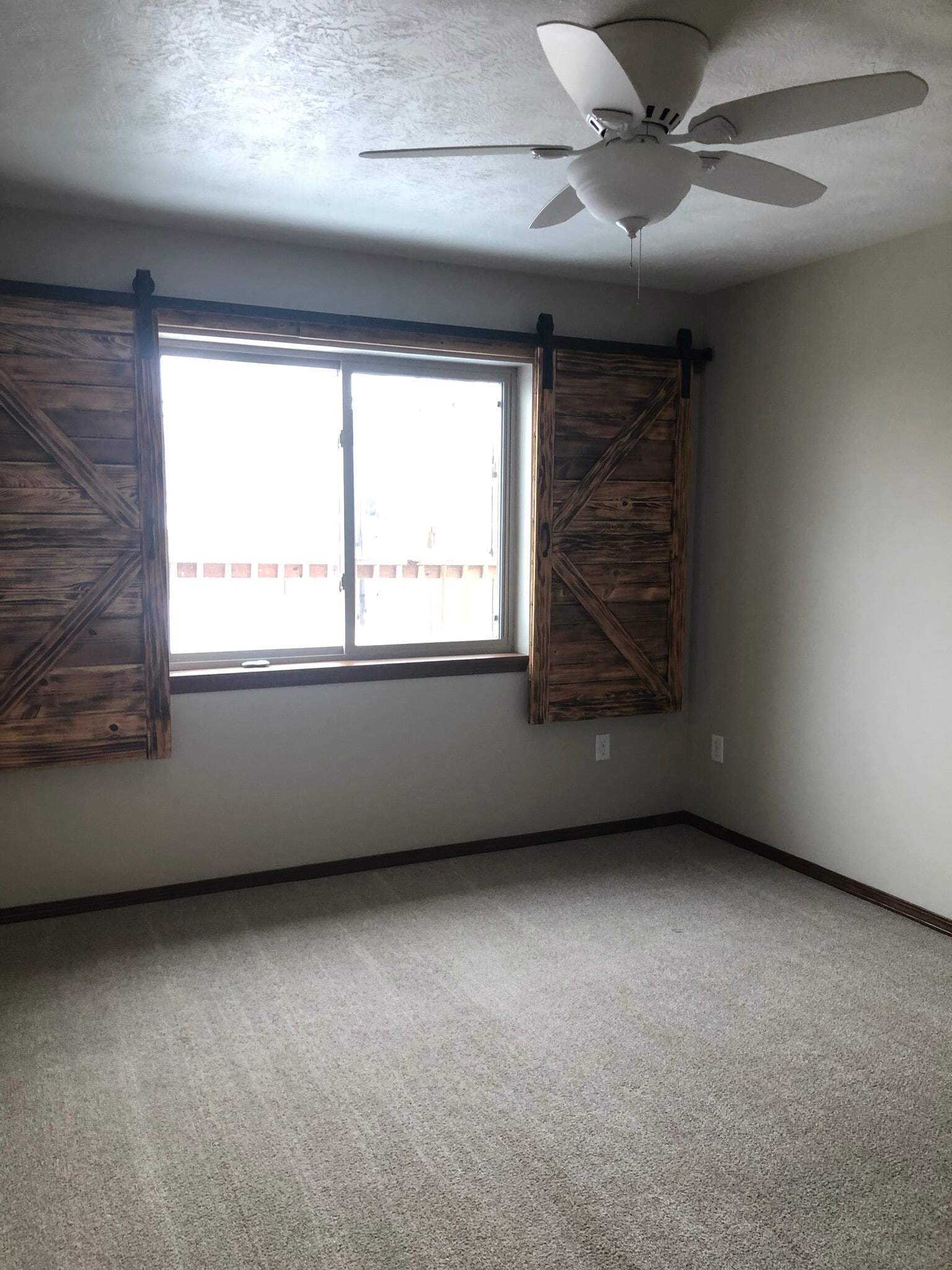 Lower level bedroom with the barn door shutter accents - 4421 S Tribbey Trl