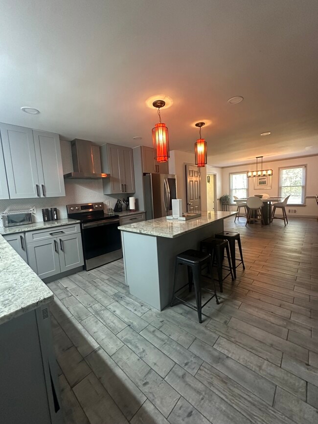 Sleek, modern kitchen with premium appliances and ample counter space. - 5460 Scofield Rd
