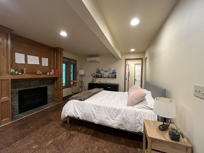 Building Photo - One-of-a-Kind Custom Home with Wall of Windows, Stone Fireplaces, Expansive Entertainment Space &...
