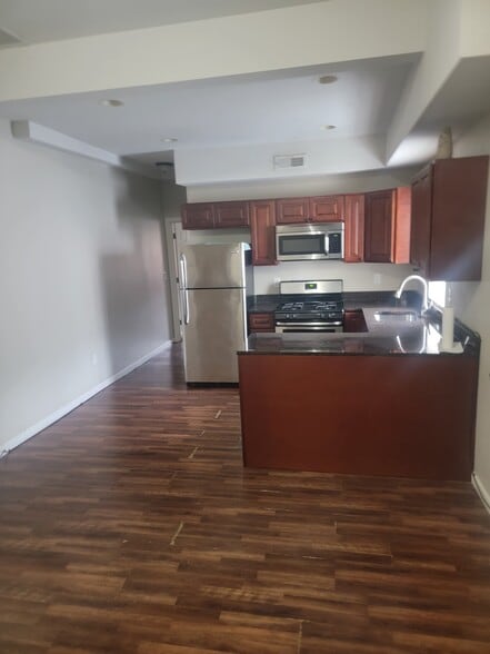 Eat in kitchen with lovely granite countertops gas stove, dishwasher and stainless steel refrigerato - 5201 Germantown Ave