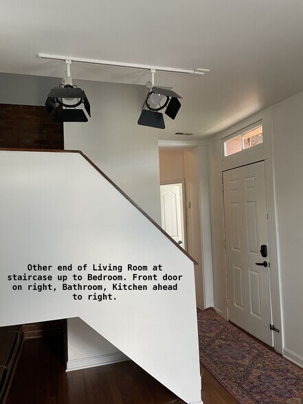 Other end of living room has stairs to 3rd floor bedroom. Entry door to the right - 810 E Washington St