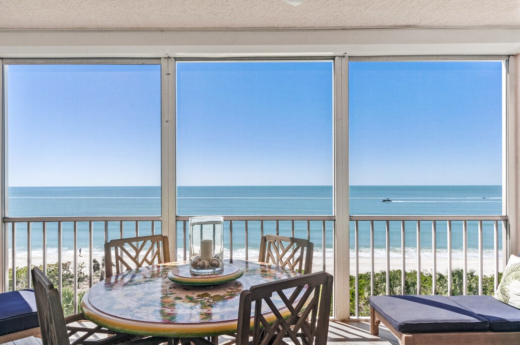 dining, sofa with ottoman, two lounge chairs - 253 Barefoot Beach Blvd