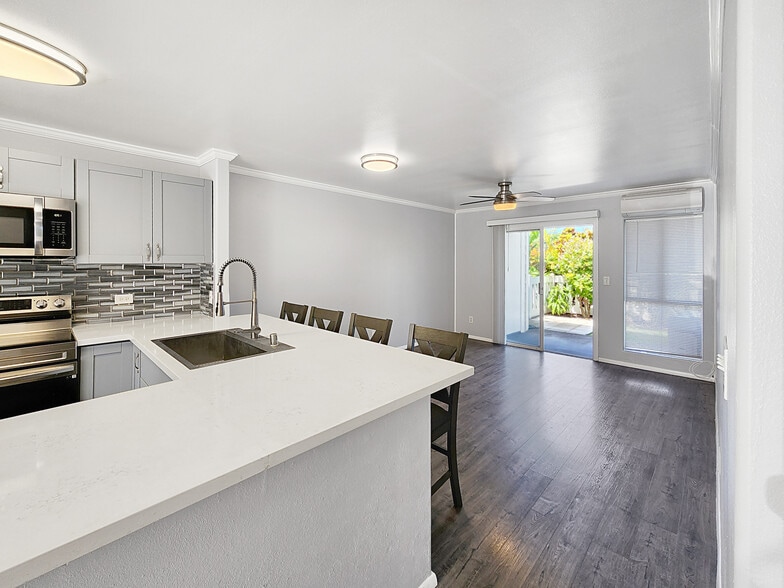 Kitchen quartz counters extend to bar dining area and open to living area - 75-6081 Alii Dr