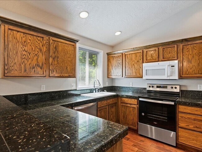 Building Photo - June Rent Free!!  Move Today!  Four Bedroom, Three Bath Home with Beautiful Backyard, Two Car Gar...
