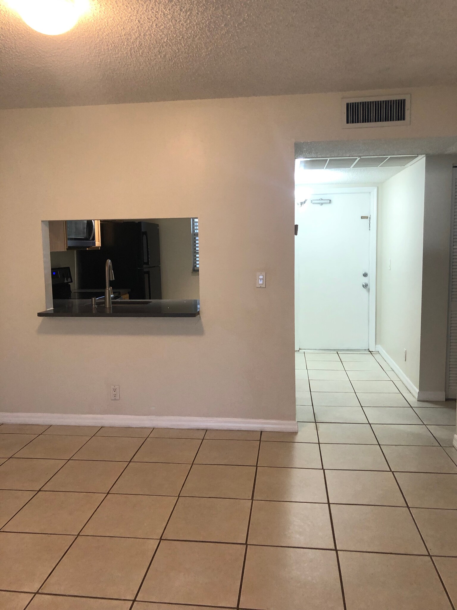 view kitchen/hallway from livingroom - 9480 Poinciana Pl