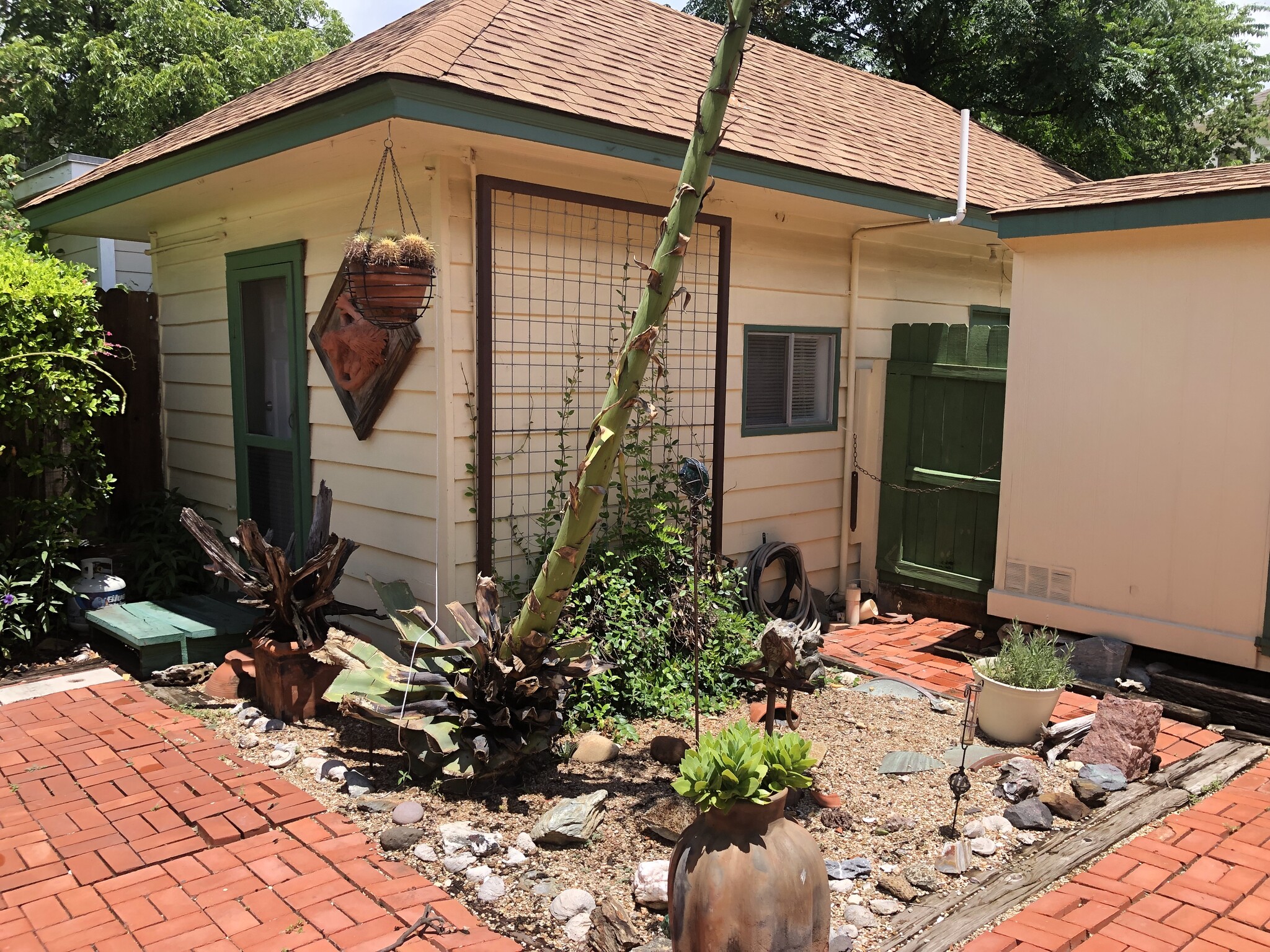 Xeriscaped patio entrance with original sculptures and artwork - 508 Bellevue Pl