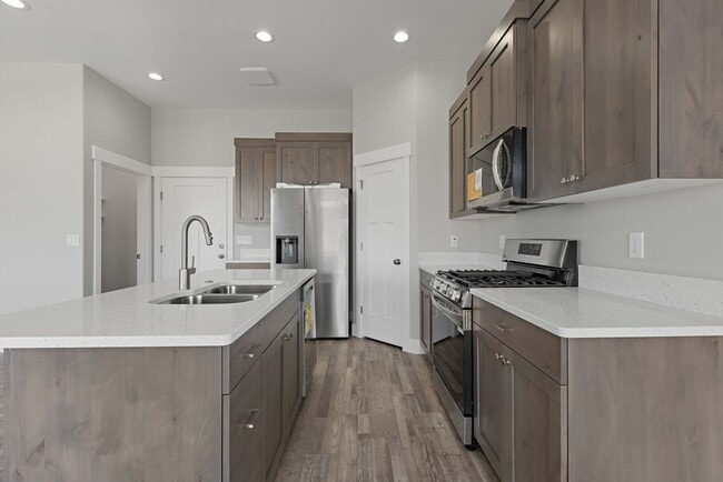 Building Photo - NEW HOME with large garage stalls and unfinished basement for additional storage