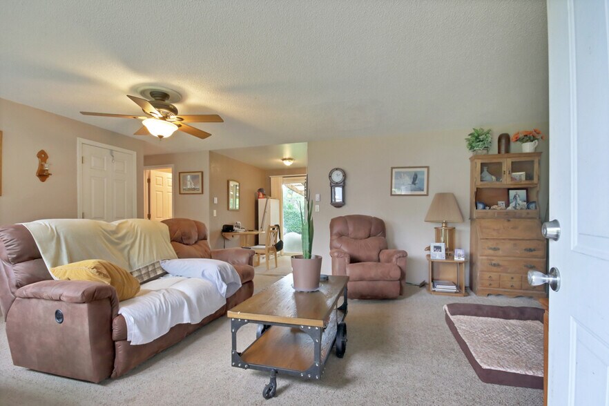 Livingroom looking toward back, patio. Carpet is gone, hardwood floors exposed and refinished. - 7017 Sacramento St SW