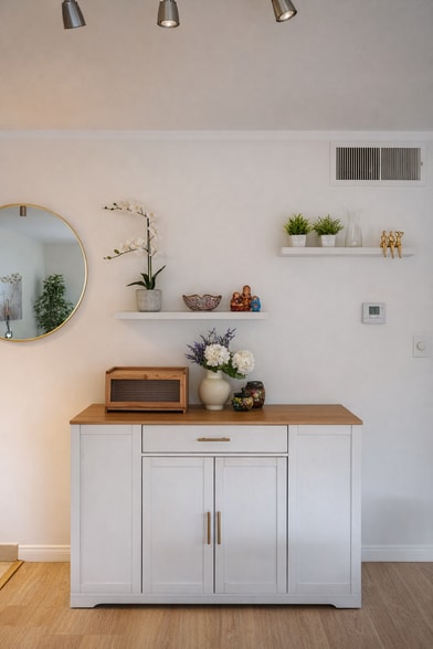 Clean entry accent with mirror and storage. - 4401 Kraft Ave