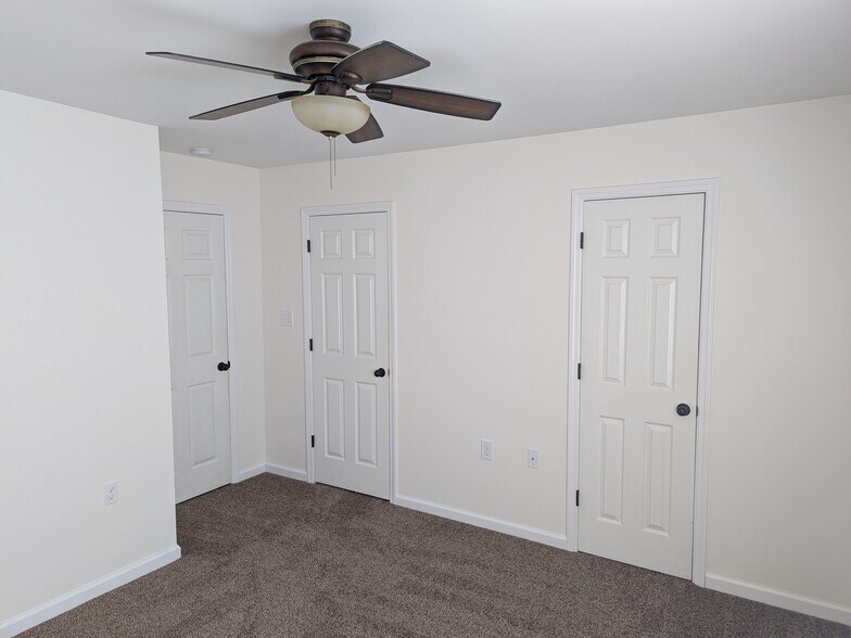 Master bathroom with primary door, closet door, and bathroom door - 2237 Spring Meadow Ln SE