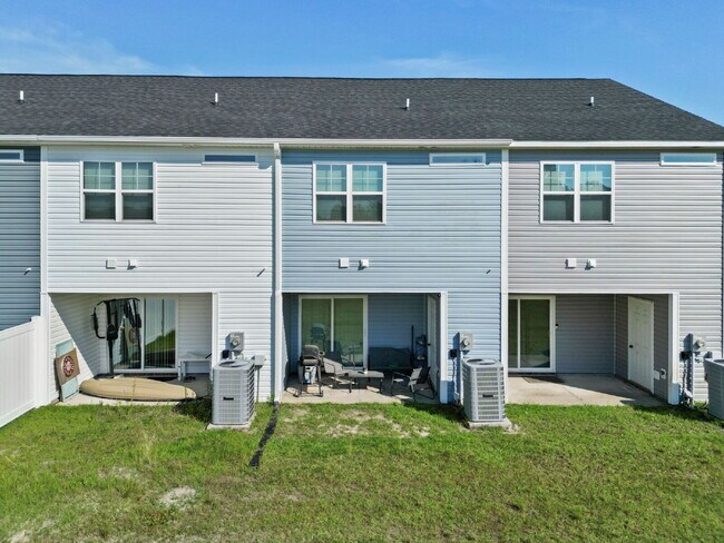 Building Photo - Available Now! Enjoy low-maintenance coastal living in this beautiful 2-bedroom, 2.5-bath townhom...