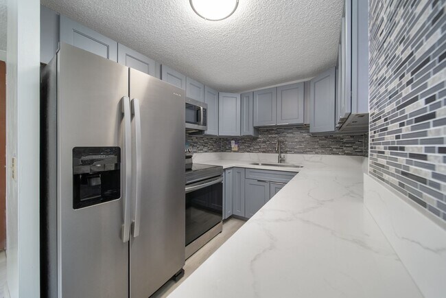 Building Photo - Upgraded Fully Furnished Condo w/ Assigned...