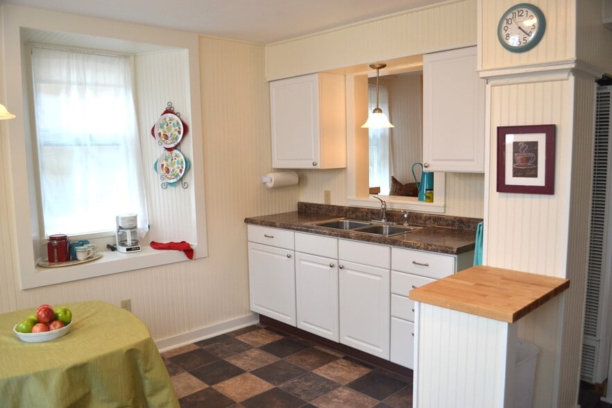 The sink pass-thru looks into the living room. - 222 W Case St