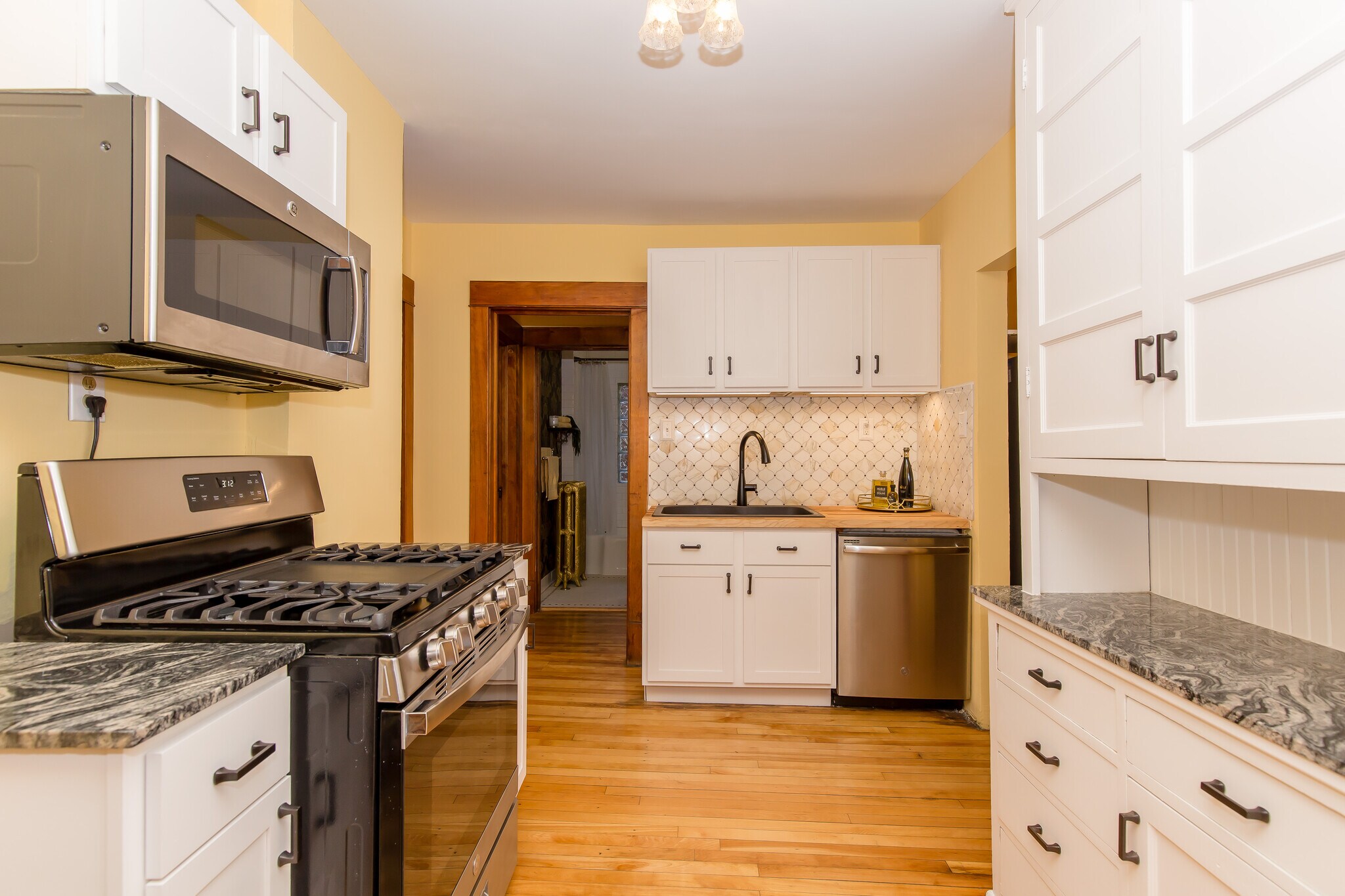 Kitchen is stacked with Stainless Steel appliances microwave, refrigerator, gas range, dishwasher - 715 5th St SE