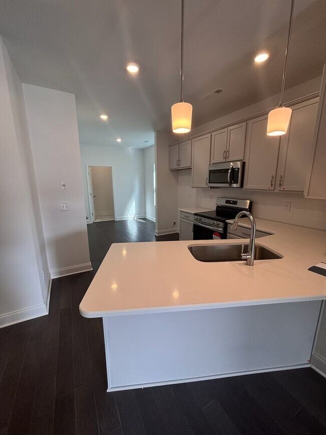 Building Photo - **BE THE LUCKY ONE TO LIVE IN THIS 2024-BUILT END-UNIT TOWNHOME IN A RESORT-STYLE COMMUNITY**