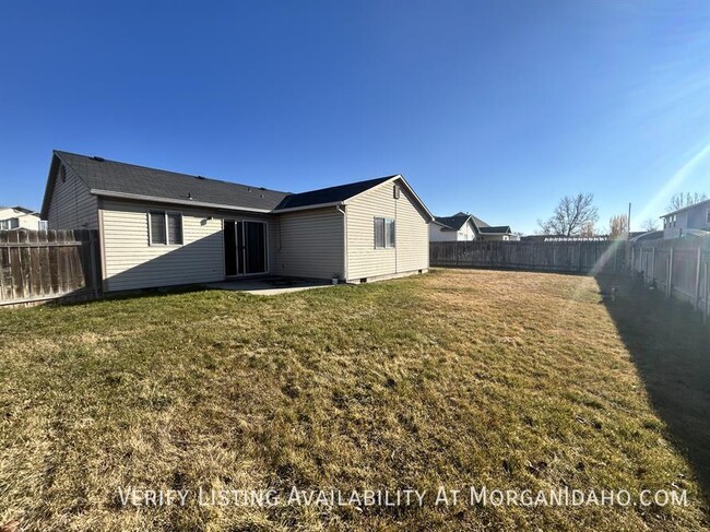 Building Photo - Three car garage, Fully fenced, Large back...