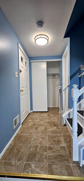 Tiled Foyer | Tiled entry foyer with a full-width coat closet and a bright overhead fixture - 43 Tynemouth Ct