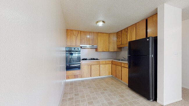 Experience culinary delight in this modern kitchen with ample storage. - Flats at Sloan's Lake West
