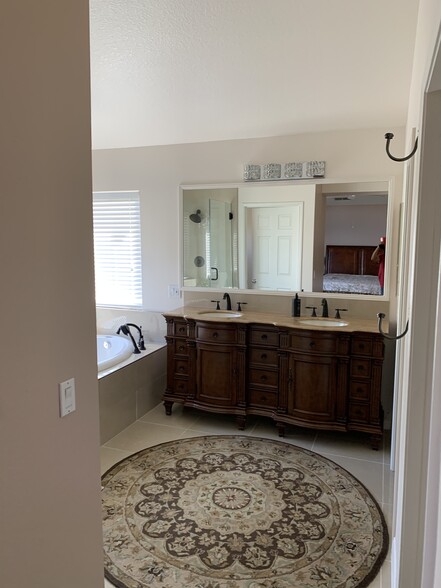 Roman bathtub with overhanging chandelier - 24633 Stagg St