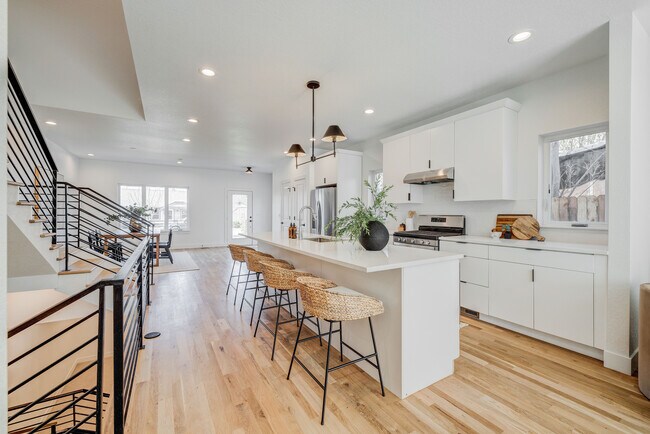 Kitchen with front door and dining room in background - 3420 S Grant St